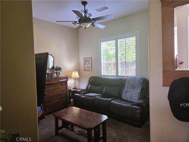 carpeted living area featuring visible vents and ceiling fan