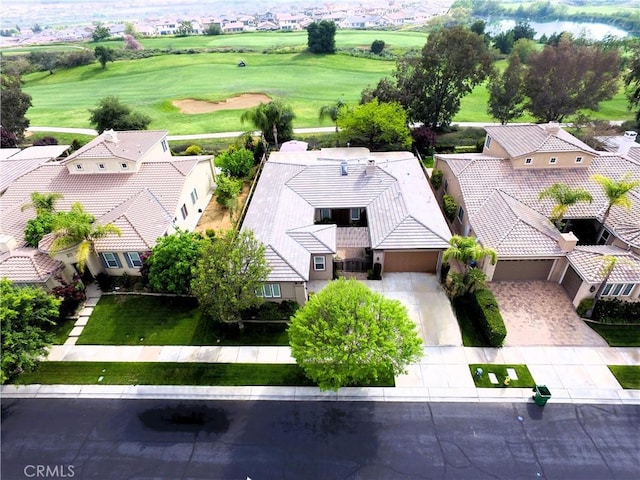 birds eye view of property with golf course view and a residential view