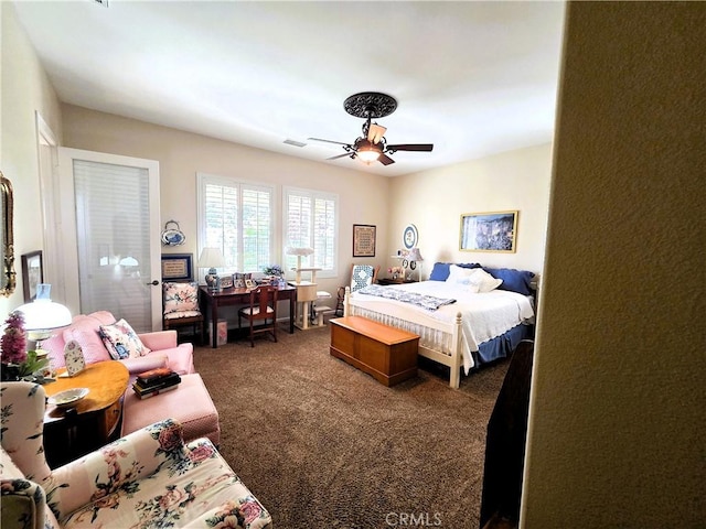 bedroom with visible vents, a ceiling fan, and carpet