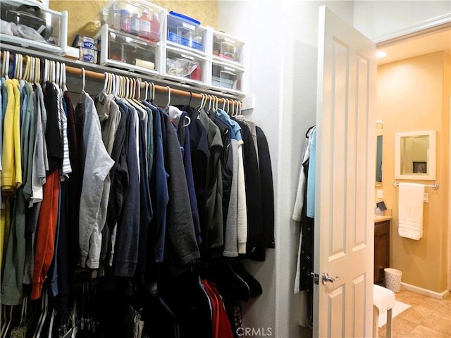 spacious closet with tile patterned floors