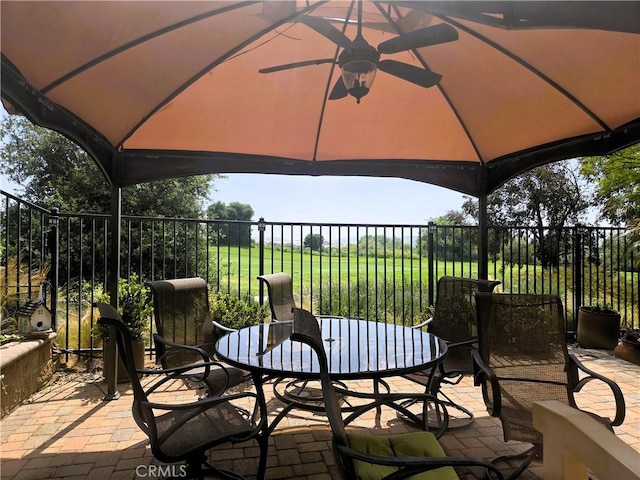 view of patio featuring outdoor dining area and fence
