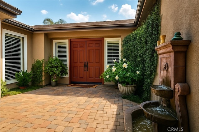 entrance to property with stucco siding