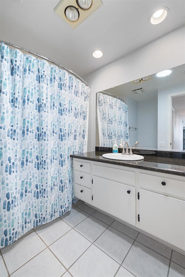 bathroom with visible vents, curtained shower, tile patterned floors, and vanity