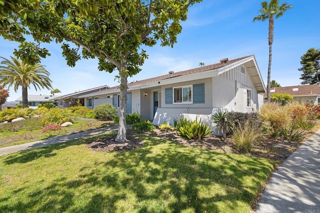 single story home featuring stucco siding and a front lawn