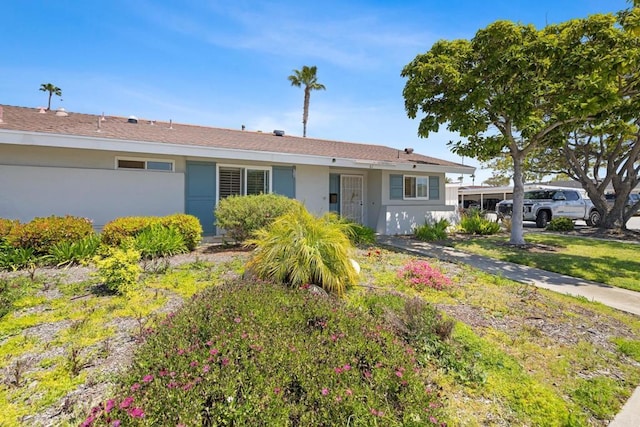 single story home featuring stucco siding