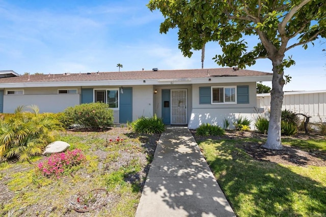 single story home featuring stucco siding
