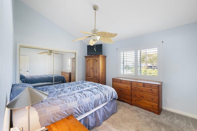 bedroom with a ceiling fan, carpet floors, baseboards, a closet, and lofted ceiling