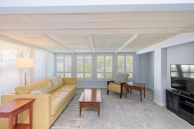 living area featuring beamed ceiling, baseboards, carpet, and wood ceiling