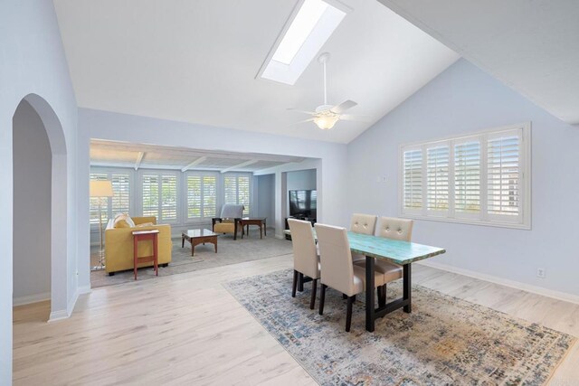 3685 Vista Campana N Unit 61, Oceanside, CA 92057 - dining space with a skylight, wood finished floors, lofted ceiling, arched walkways, and a ceiling fan