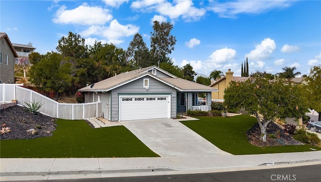 ranch-style home featuring fence, driveway, and a front yard