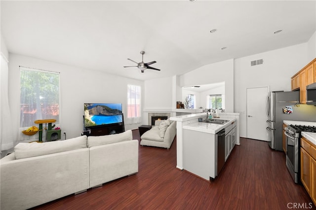 kitchen with appliances with stainless steel finishes, a ceiling fan, open floor plan, and visible vents