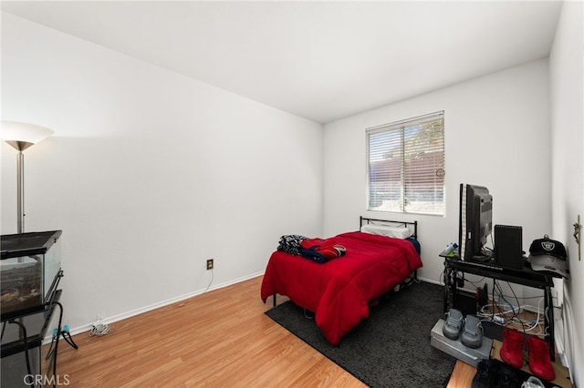 bedroom with baseboards and light wood-style floors