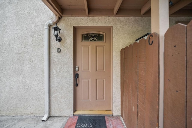 property entrance with stucco siding