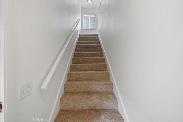stairs with baseboards and carpet flooring