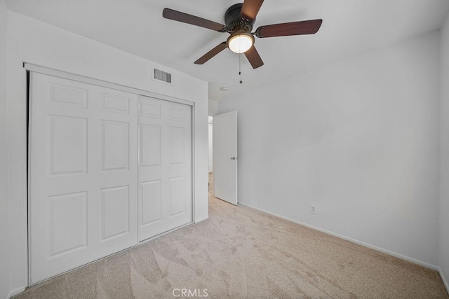 unfurnished bedroom featuring visible vents, a closet, baseboards, ceiling fan, and carpet flooring