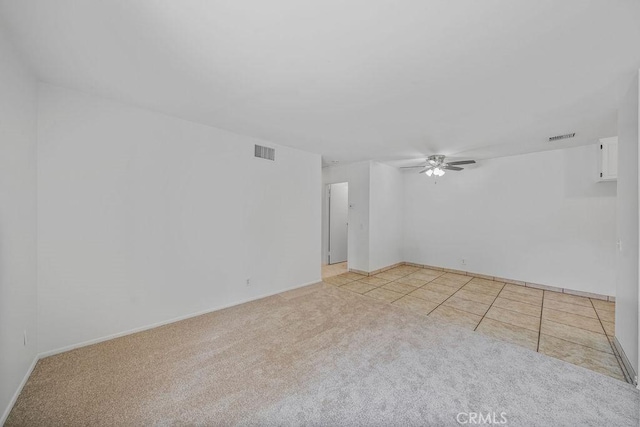 unfurnished room featuring visible vents, baseboards, ceiling fan, and light colored carpet
