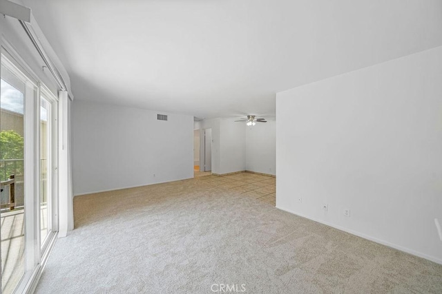 unfurnished room with carpet floors, ceiling fan, and visible vents