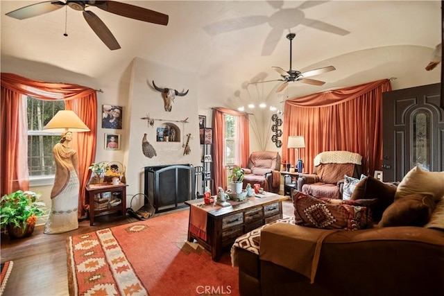 living room featuring a ceiling fan, vaulted ceiling, and wood finished floors