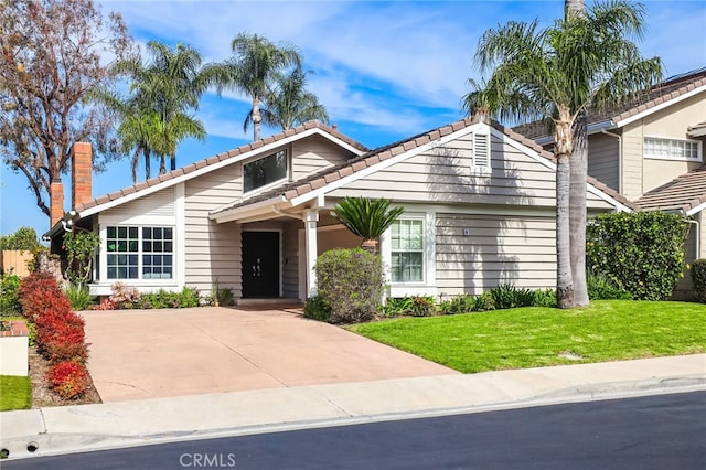 8 Recodo, Irvine, CA 92620 - view of front of house with a tiled roof, a front yard, and a chimney