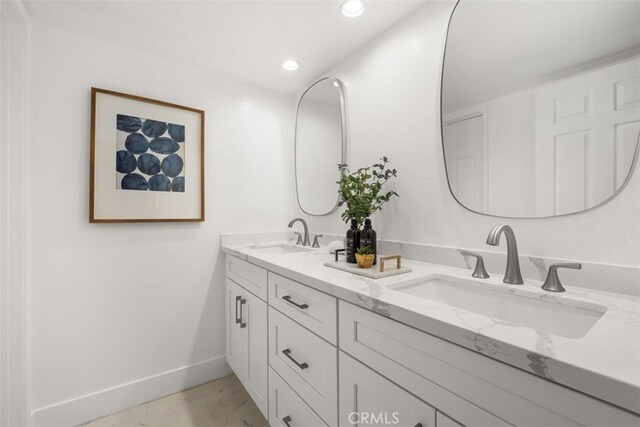 8 Recodo, Irvine, CA 92620 - full bathroom featuring double vanity, marble finish floors, and recessed lighting