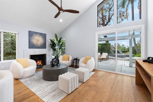 8 Recodo, Irvine, CA 92620 - living room with high vaulted ceiling, a high end fireplace, wood finished floors, ceiling fan, and recessed lighting
