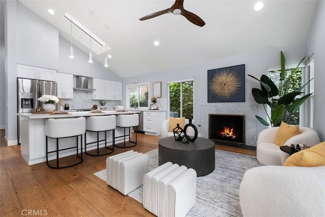 8 Recodo, Irvine, CA 92620 - living area featuring vaulted ceiling, recessed lighting, a skylight, light wood-type flooring, and ceiling fan
