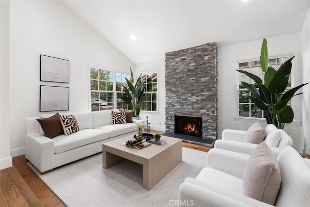 8 Recodo, Irvine, CA 92620 - living area with wood finished floors, a stone fireplace, recessed lighting, high vaulted ceiling, and baseboards