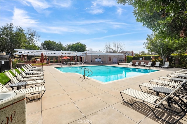 community pool featuring a pergola, a patio, and fence
