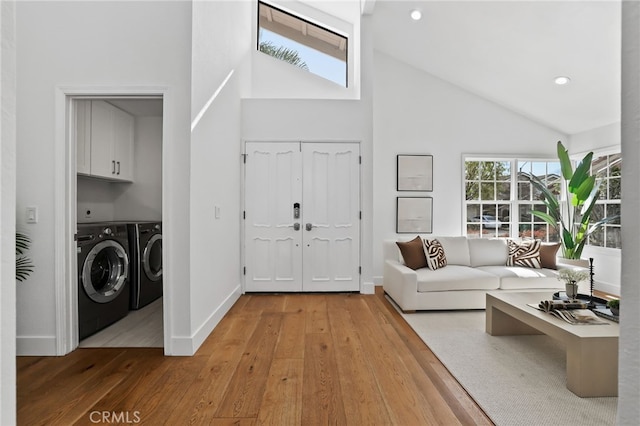 8 Recodo, Irvine, CA 92620 - living area with washer and clothes dryer, high vaulted ceiling, hardwood / wood-style floors, baseboards, and recessed lighting