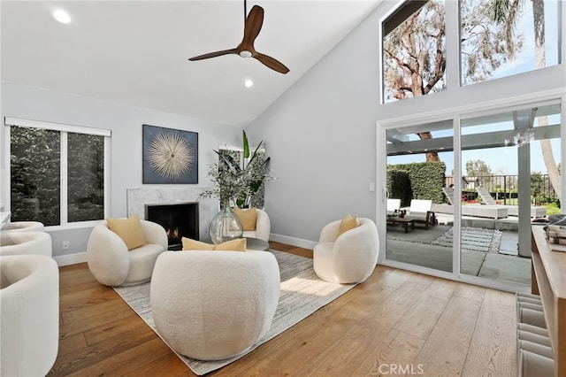 8 Recodo, Irvine, CA 92620 - living area featuring high vaulted ceiling, a high end fireplace, wood-type flooring, baseboards, and recessed lighting