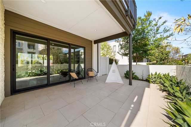 view of patio / terrace featuring fence