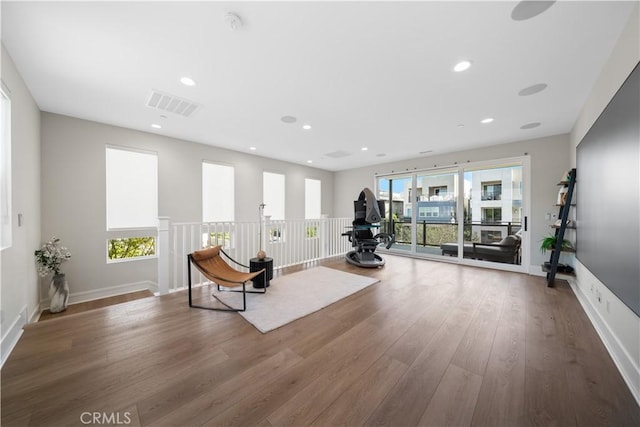 interior space featuring baseboards, recessed lighting, wood finished floors, and visible vents
