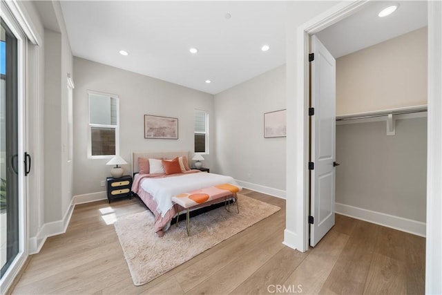bedroom with recessed lighting, baseboards, and light wood finished floors