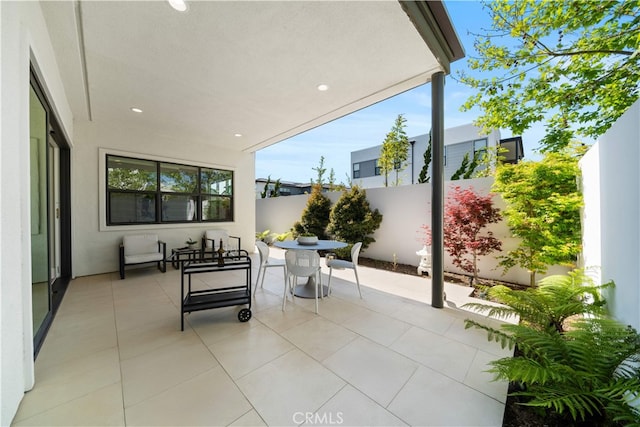 view of patio with outdoor dining area and a fenced backyard