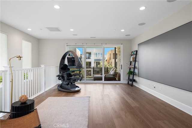 exercise area with recessed lighting, baseboards, visible vents, and wood finished floors