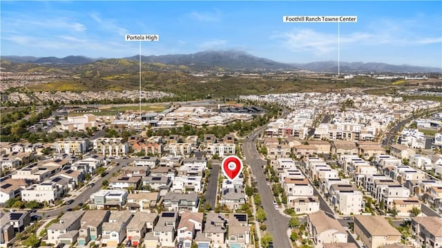 birds eye view of property with a mountain view and a residential view