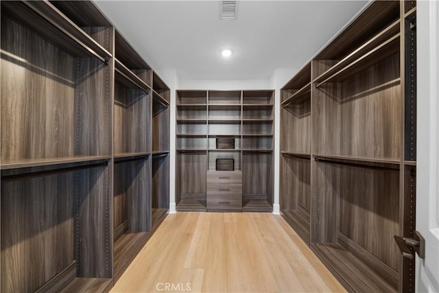 walk in closet with visible vents and wood finished floors