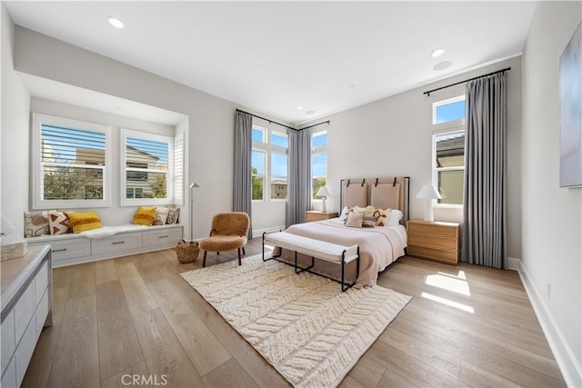 bedroom featuring recessed lighting, baseboards, and light wood-type flooring