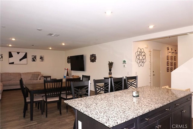 1322 Division Ct, Hemet, CA 92543 - kitchen featuring open floor plan, dark wood-style floors, light stone countertops, recessed lighting, and a center island