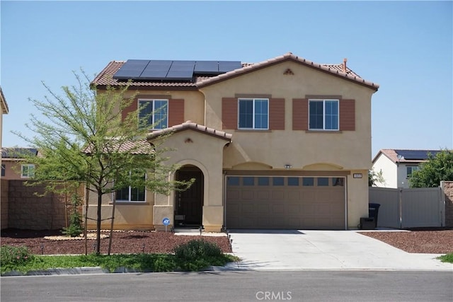 1322 Division Ct, Hemet, CA 92543 - mediterranean / spanish house with an attached garage, roof mounted solar panels, stucco siding, concrete driveway, and a tiled roof