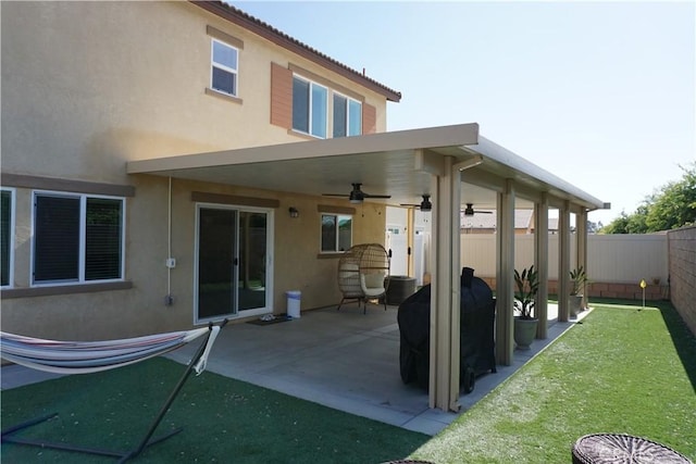 1322 Division Ct, Hemet, CA 92543 - rear view of property featuring a ceiling fan, stucco siding, a fenced backyard, and a patio area