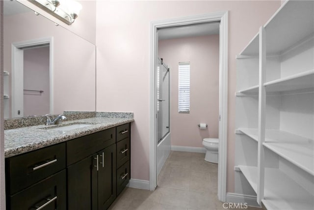 full bathroom featuring tile patterned flooring, vanity, toilet, baseboards, and combined bath / shower with glass door