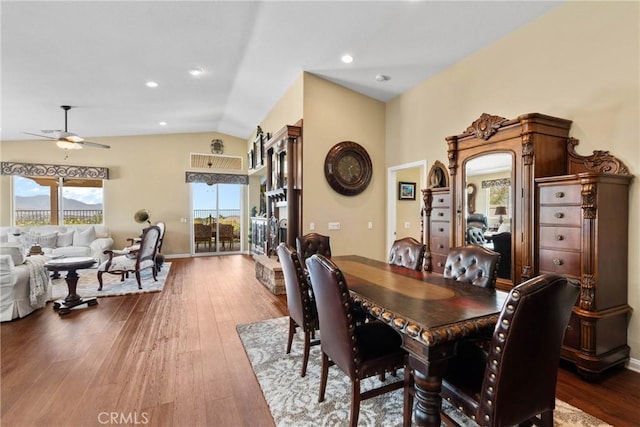 dining space featuring ceiling fan, lofted ceiling, and hardwood / wood-style floors