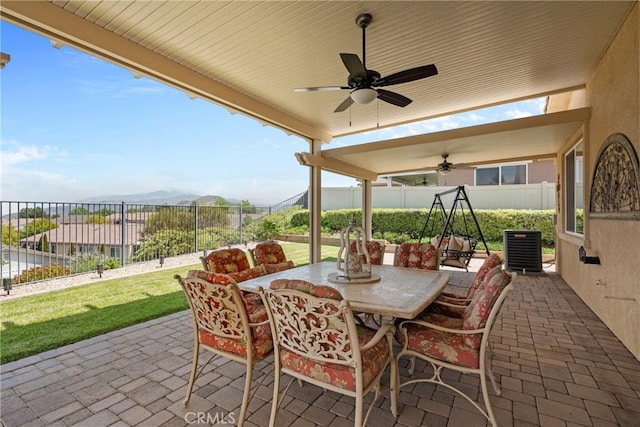 view of patio / terrace with ceiling fan, central AC, outdoor dining area, and a fenced backyard