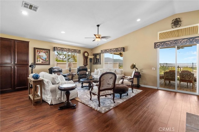 living area with visible vents, dark wood-style flooring, ceiling fan, and lofted ceiling