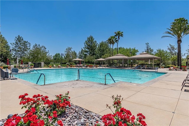 community pool featuring a patio, a gazebo, and fence
