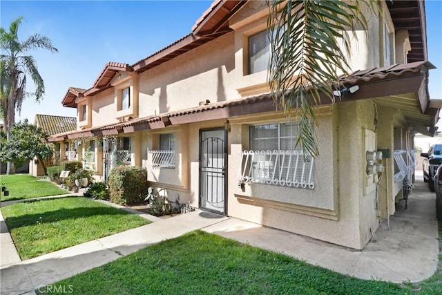 542 W Grand Ave, Pomona, CA 91766 - exterior space with a tiled roof, a front yard, and stucco siding