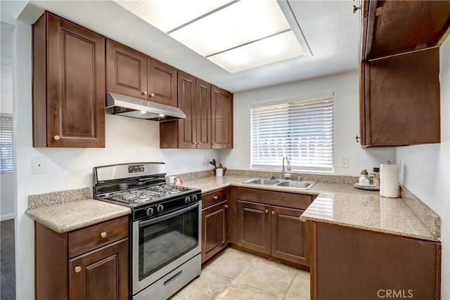 542 W Grand Ave, Pomona, CA 91766 - kitchen featuring stainless steel range with gas stovetop, a sink, light tile patterned floors, and under cabinet range hood