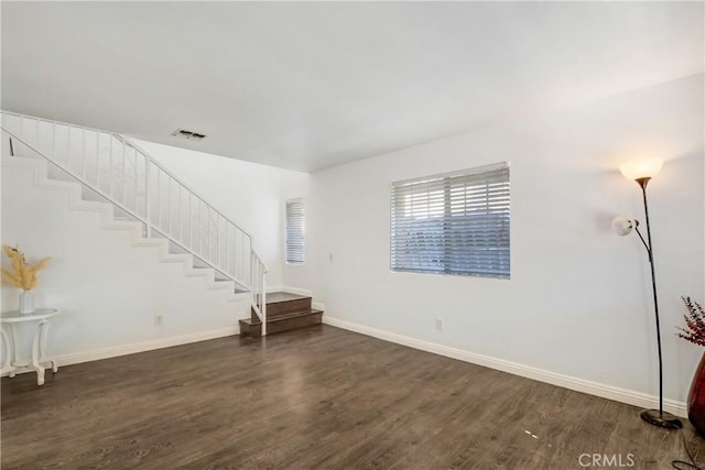 542 W Grand Ave, Pomona, CA 91766 - unfurnished living room with stairway, baseboards, dark wood finished floors, and visible vents