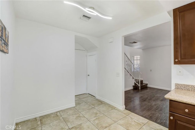 542 W Grand Ave, Pomona, CA 91766 - empty room with visible vents, stairs, light tile patterned floors, and baseboards